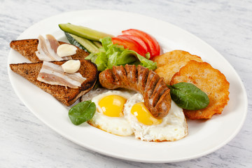 Hearty breakfast. Potato pancakes with sausage, fried egg