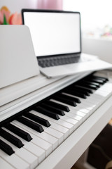 Fototapeta na wymiar Coronavirus. Quarantine. Online piano music learning with a laptop, education and remote work. 