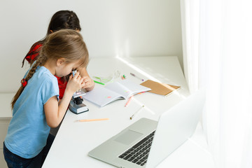 Obraz na płótnie Canvas Learning from home, Home school kid concept. Little children study online learning from home with laptop. Quarantine and Social distancing concept.