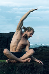 Fototapeta na wymiar Athlete man practicing yoga outdoors photograph