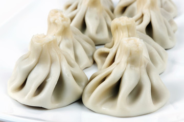 Khinkali (Georgian dumpling) on a white surface