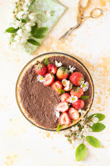 Steam cooked cake decorating with daisies, strawberry and chocolate sauce.