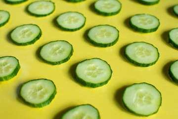 cucumber slices are placed on a colored glass table