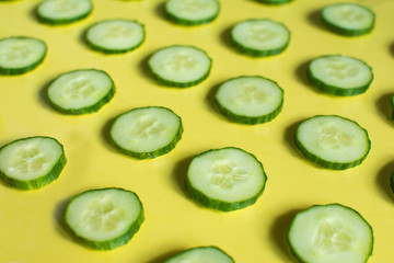 cucumber slices are placed on a colored glass table