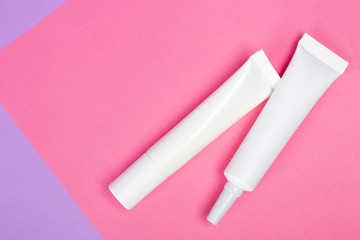 Cosmetic tube mock up isolated on pink background. Lotion skin care bottle template. Beauty concept.