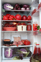 Refrigerator, content. Color diet. Organic red food. Red nutrition in fridge, refrigerator. Healthy, dietary nutrition. Red vegetables, fruits, meat, fish, dishes. Products for diet. Red color. Eating