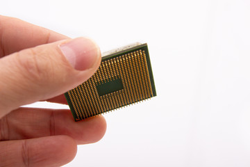 Microprocessor in hand. Golden pins facing up. The concept of new technologies