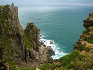 view of the sea on a cloudy day on the coast of which there are beautiful cliffs