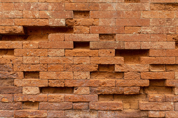 A curious very regular ancient brick wall, built without mortar. The structure built in neo-Gothic style belongs to a building located in Venice along Via Nova. Italy.
