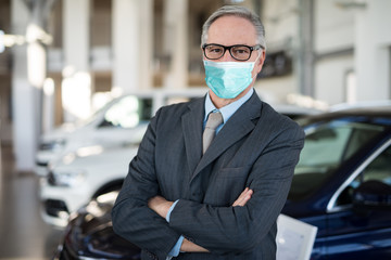 Car dealer principal inside showroom during coronavirus pandemic