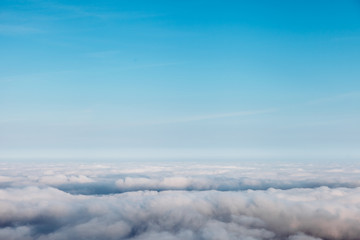 bird eye view at clouds in blue sky top view from drone from airplane window