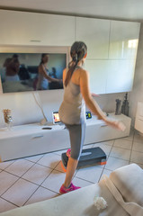 Woman doing workout inside her house