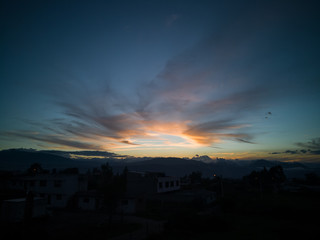 Sunset with clouds and mountains in the background