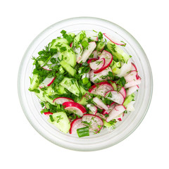 Radish and cucumber salad with herbs in a salad bowl on a white isolated background. Tasty and healthy food. Flat lay.