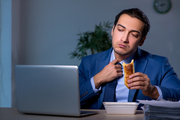 Hungry employee working late in the office