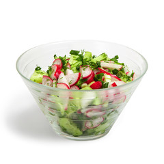 Radish and cucumber salad with herbs in a salad bowl on a white isolated background. Healthy food.