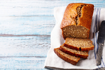 Healthy vegan oat and banana loaf bread, cake. Blue wooden background. Copy space.