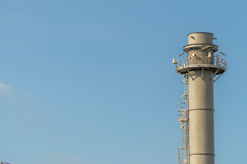 Electric plant chimney against the blue sky background, Power plant flue, copy space