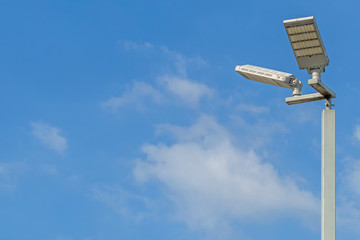 LED illuminated pole with a background of blue sky and clouds and copy space