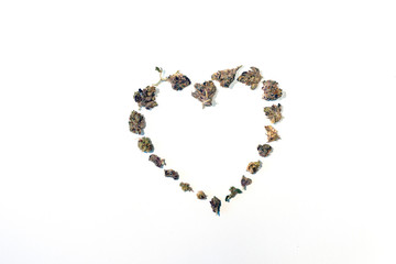 Heart shape dried marijuana cannabis pot weed buds nugs flowers isolated on white