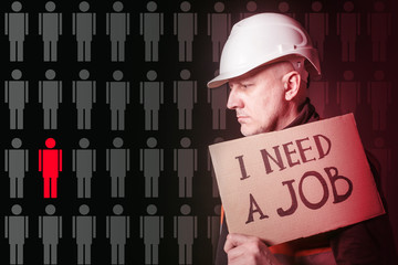 The concept of unemployment. Crisis in the labor market. A man in a construction helmet holding a...