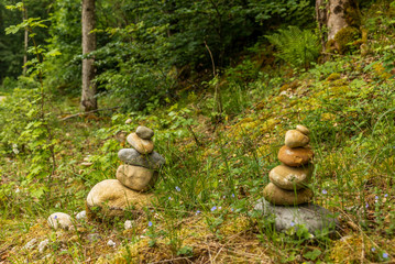 Various stone cairn in equilibrium in a Swiss forest in spring