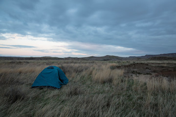 A backpacking tent set up in the backcountry wilderness of Badlands National Park in South Dakota.