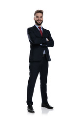happy young businessman crossing arms and smiling