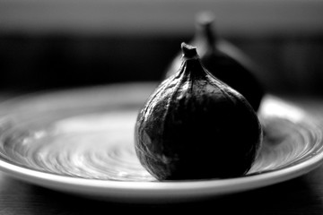 black and white photo of figs on a plate. still life. artistic photo