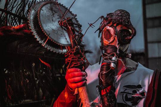 a young man in a factory during the Apocalypse in a castle and with a saw