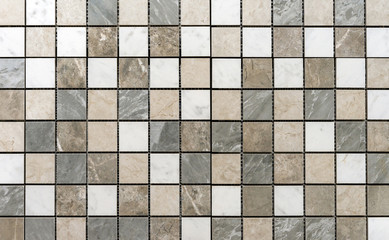 Ceramic mosaic tiles with gray and beige squares made of natural quartz to decorate the kitchen, bathroom or pool.