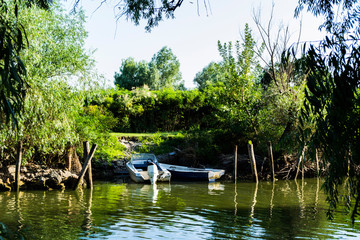 Fototapeta na wymiar Boats at shoreline in Danube Delta, Romania