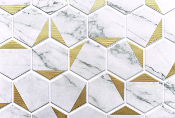 White ceramic tiles with gray stains and gold stamping. Hexagonal ceramic tile in the shape of...