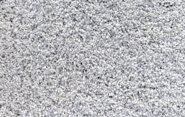 Gray carpet with a long and soft pile. Background with carpet pile.