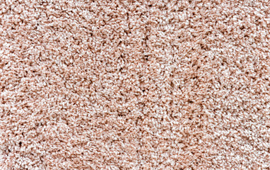Beige carpet with a long and soft pile. Background with carpet pile.