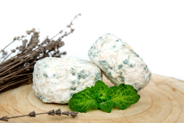 
delicious white milk soft brie cheese with blue mold for breakfast or dinner, creamy taste, decorated with mint and lavender, natural product, close-up, white background, beautiful picture