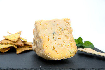 
large piece of soft blue cheese, cheese texture on a black background, white background