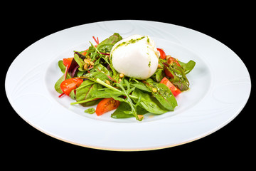 Gourmet salad with Burrata cheese, Arugula, cherry tomatoes, and basil, on a white plate, isolated on black background