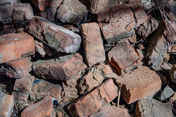 old brown bricks lie in a heap on a sunny day