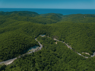 Mountain winding zig zag road. Top aerial view: cars driving on road from above.