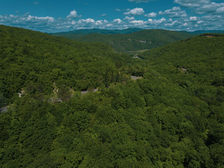Mountain winding zig zag road. Top aerial view: cars driving on road from above.