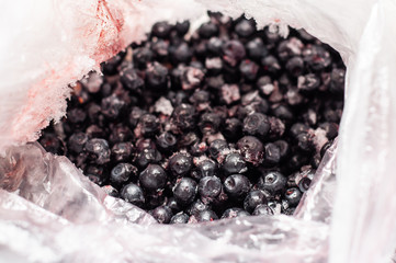 A bag of frozen blueberries in a bag, focus on the foreground