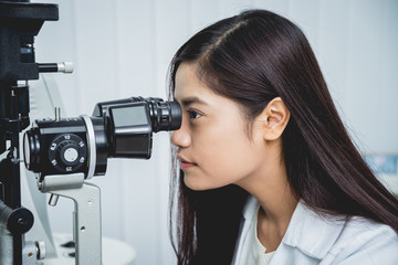 Consultation with an ophthalmologist. Young asian man and woman doctor 