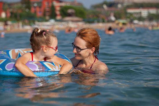 mother and daughter swim in the resort