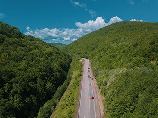 Aerial view of a rural highway between mountains