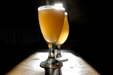 two glass of beer on dark background