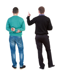 Back view of two man in sweater pointing.