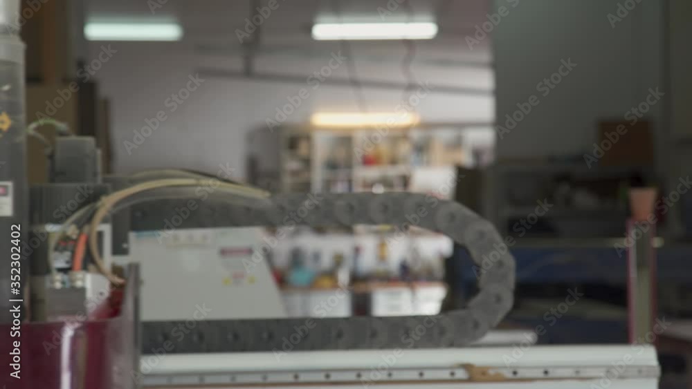 Aufkleber close up view of cnc router arm operating. large hose used to vacuum dust and debris from cutting su