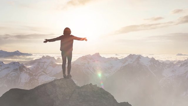 Fantasy Adventure Composite with a Girl on top of a Rock Cliff with Beautiful Canadian Mountain Nature Landscape in Background during Sunset or Sunrise. 2.5D Parallax