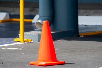 Cone signage in parking area in shopping center, reserved and empty.

